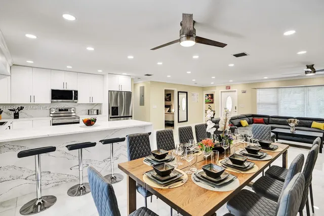 a kitchen with stainless steel appliances a stove refrigerator sink microwave and cabinets