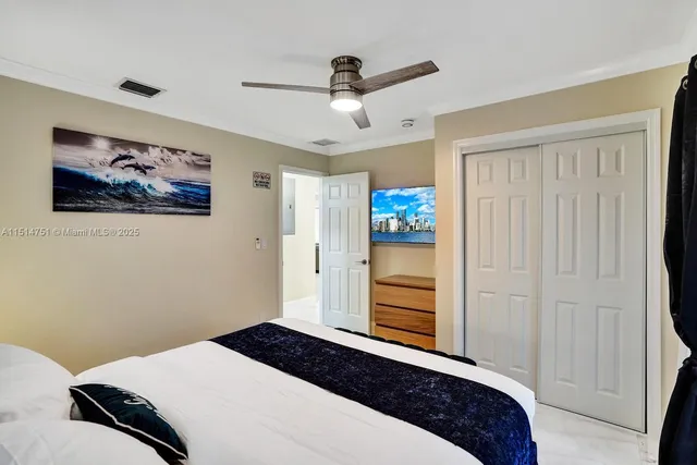 a bedroom with a bed a mirror and a closet