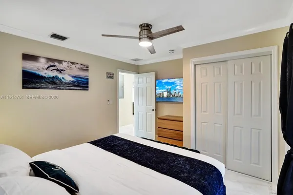 a bedroom with a bed a mirror and a closet