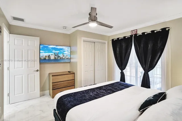 a bedroom with a bed a window and wall painting