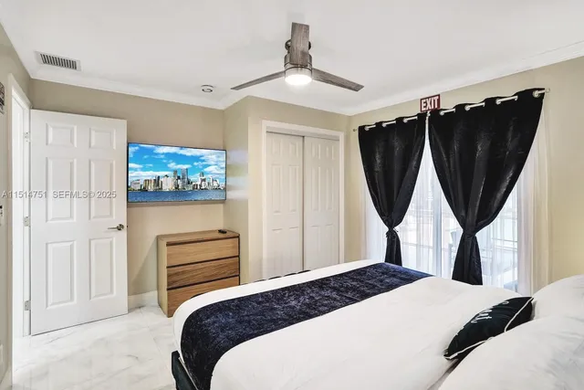 a bedroom with a bed a window and wall painting