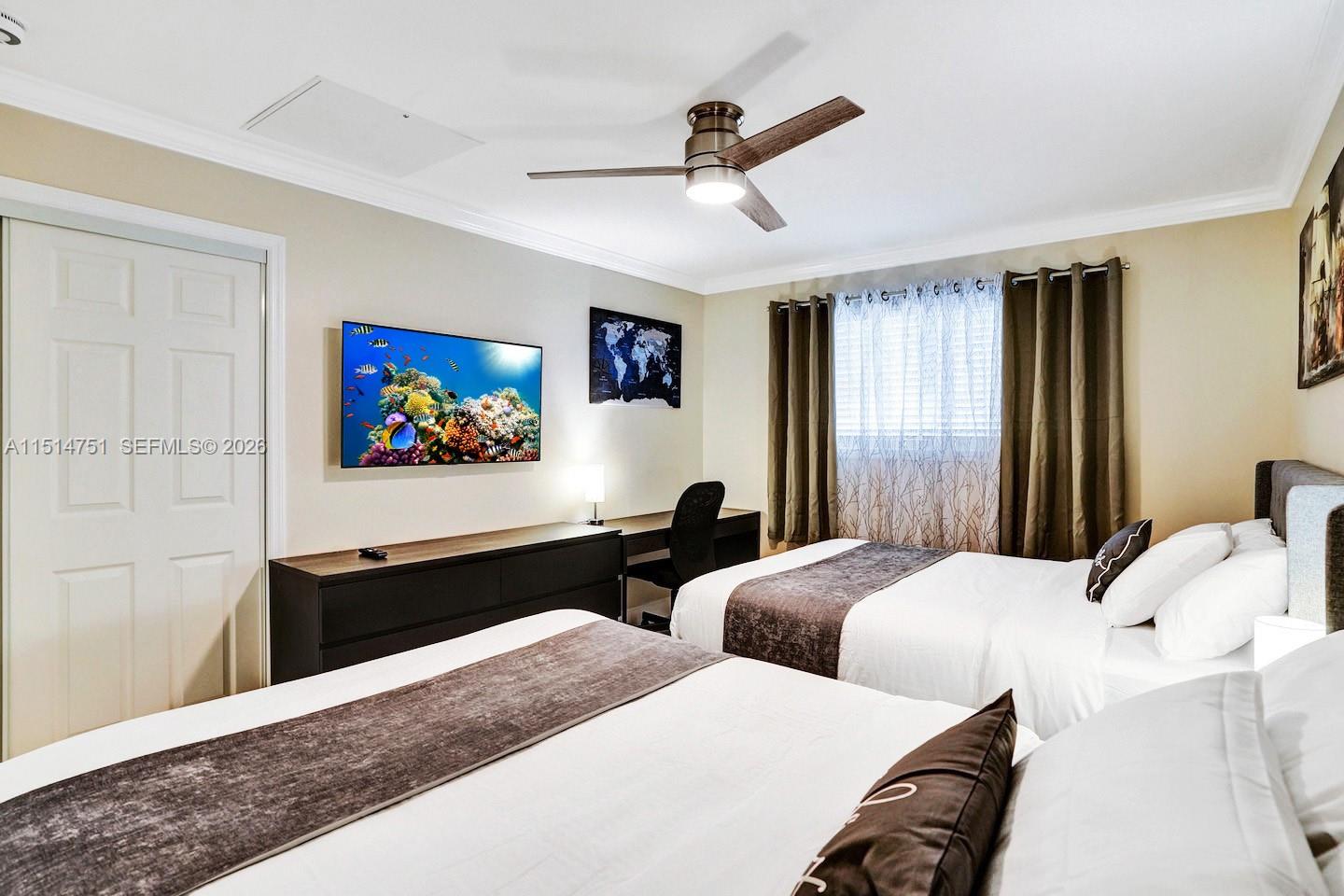 5500 Cleveland Street Hollywood, FL 33021 - Photo 24 of 45 a bedroom with two beds and a chandelier