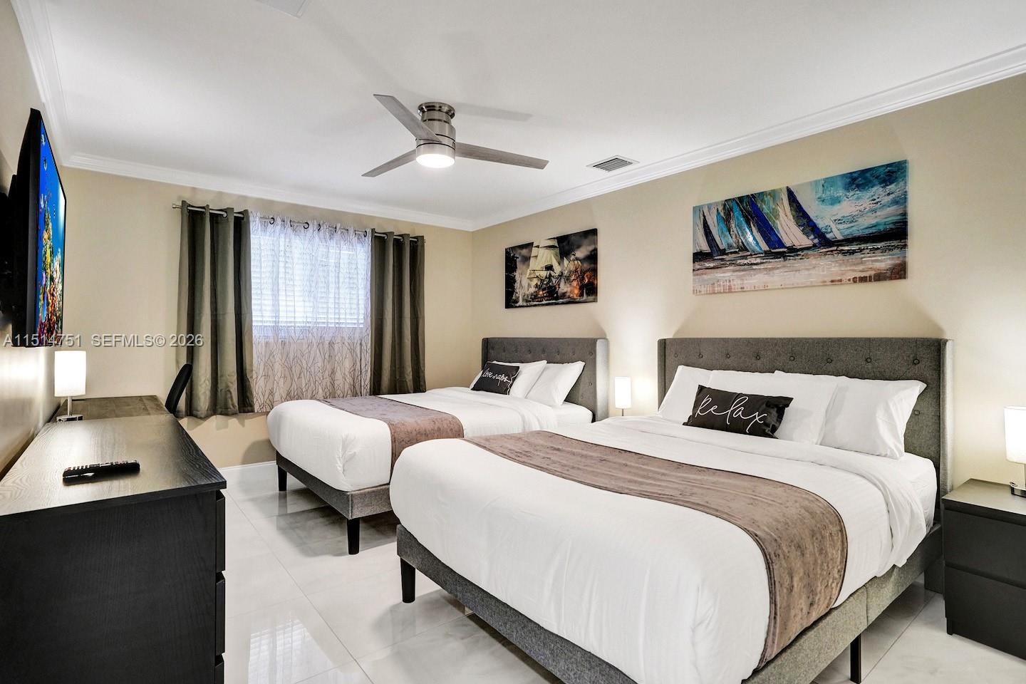 5500 Cleveland Street Hollywood, FL 33021 - Photo 25 of 45 a bedroom with bed and a flat screen tv