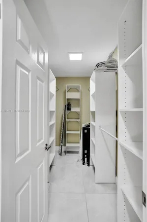 a room with a sink and a mirror