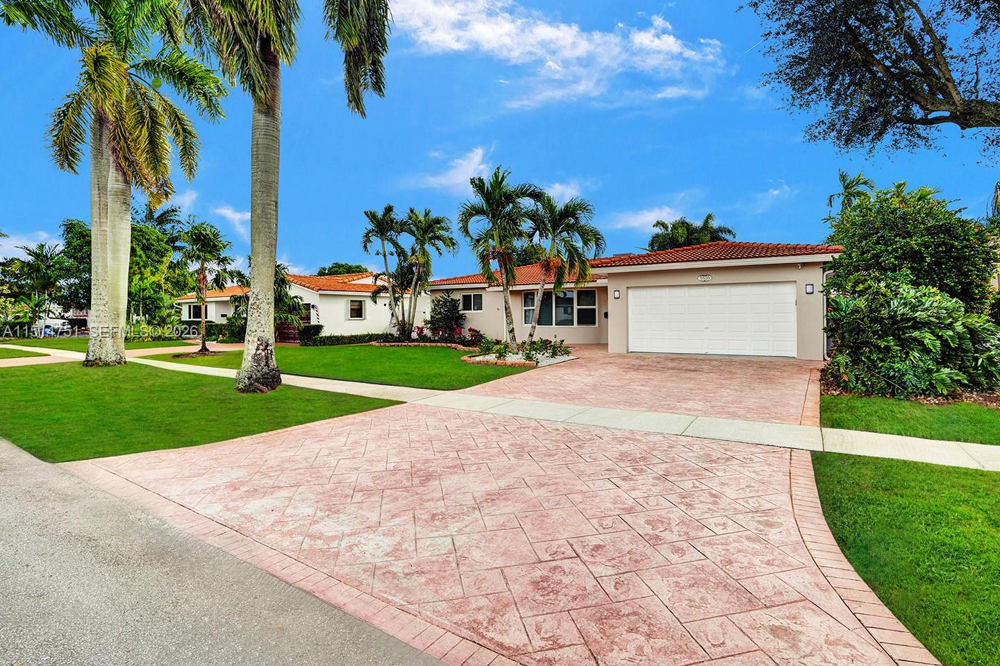 5500 Cleveland Street Hollywood, FL 33021 - Photo 3 of 45 a view of a white house with a yard and potted plants