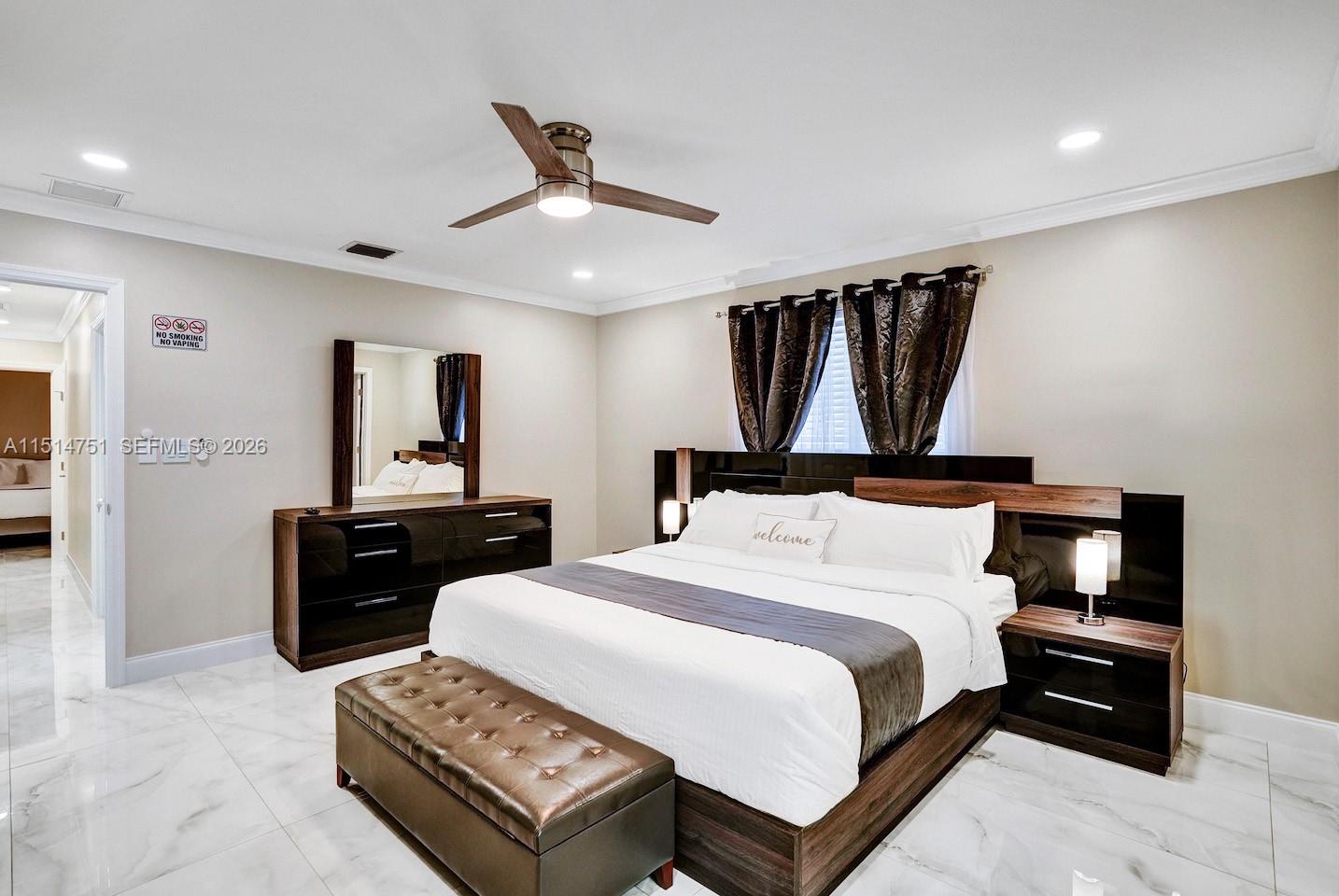 5500 Cleveland Street Hollywood, FL 33021 - Photo 31 of 45 a bedroom with a bed and wooden floor