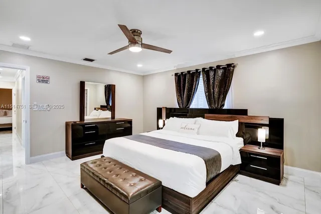 a bedroom with a bed a mirror and a window