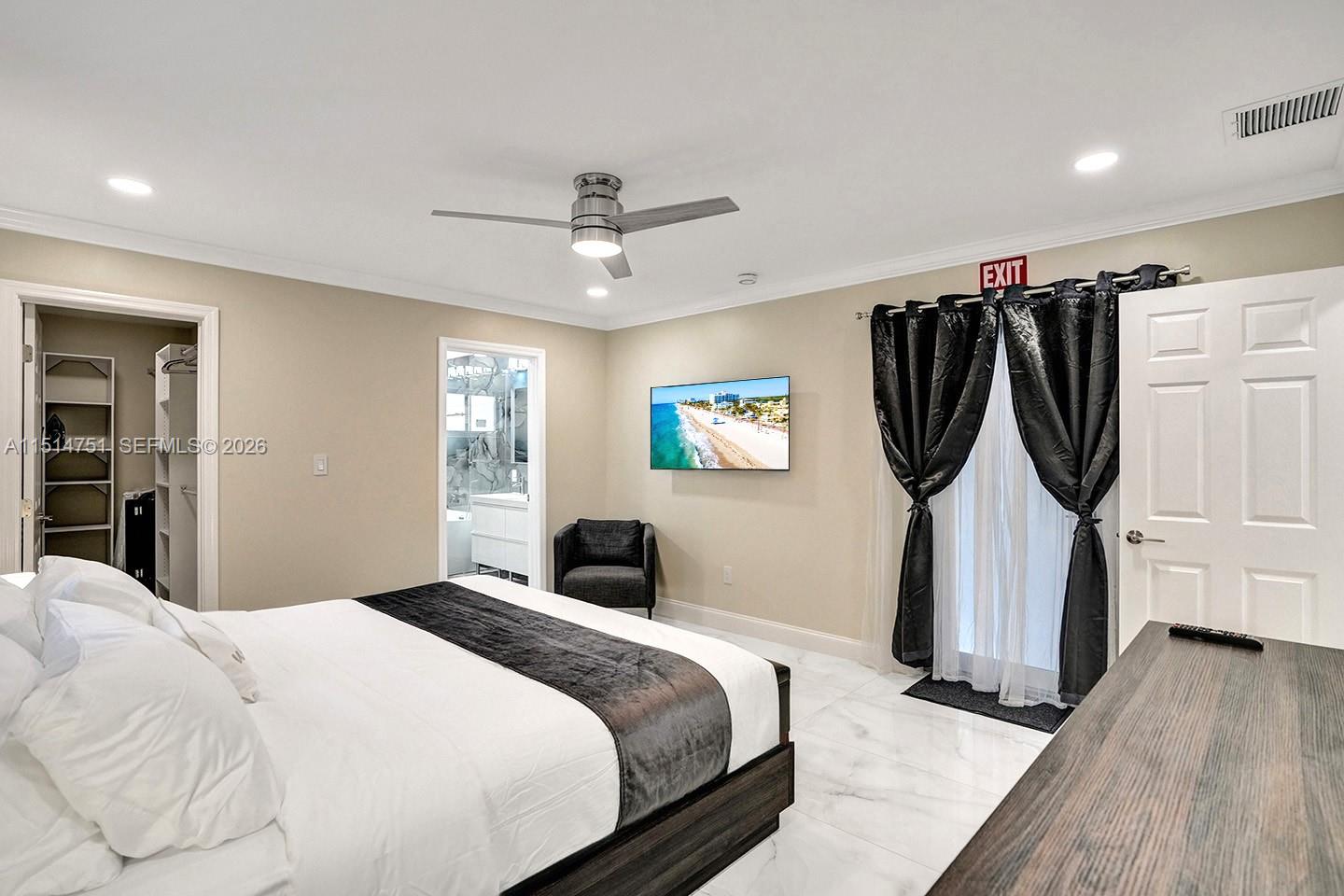 5500 Cleveland Street Hollywood, FL 33021 - Photo 32 of 45 a bedroom with a bed a mirror and a window