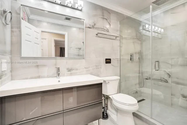 a bedroom with two beds and a chandelier