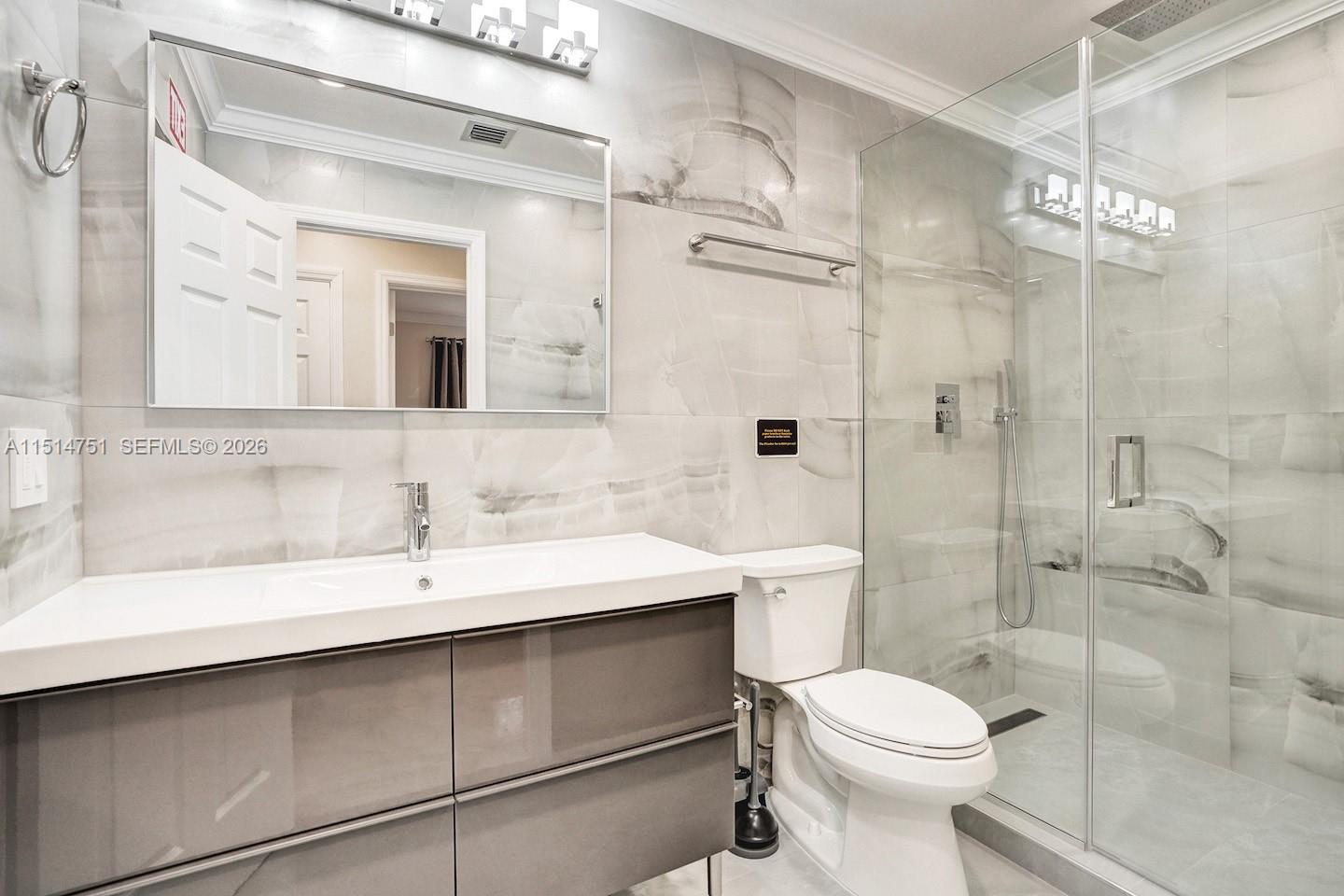 5500 Cleveland Street Hollywood, FL 33021 - Photo 35 of 45 a bathroom with a sink a toilet and shower