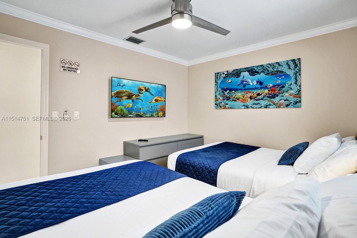 5500 Cleveland Street Hollywood, FL 33021 - Photo 37 of 45 a view of a bedroom with two beds and a painting on the wall