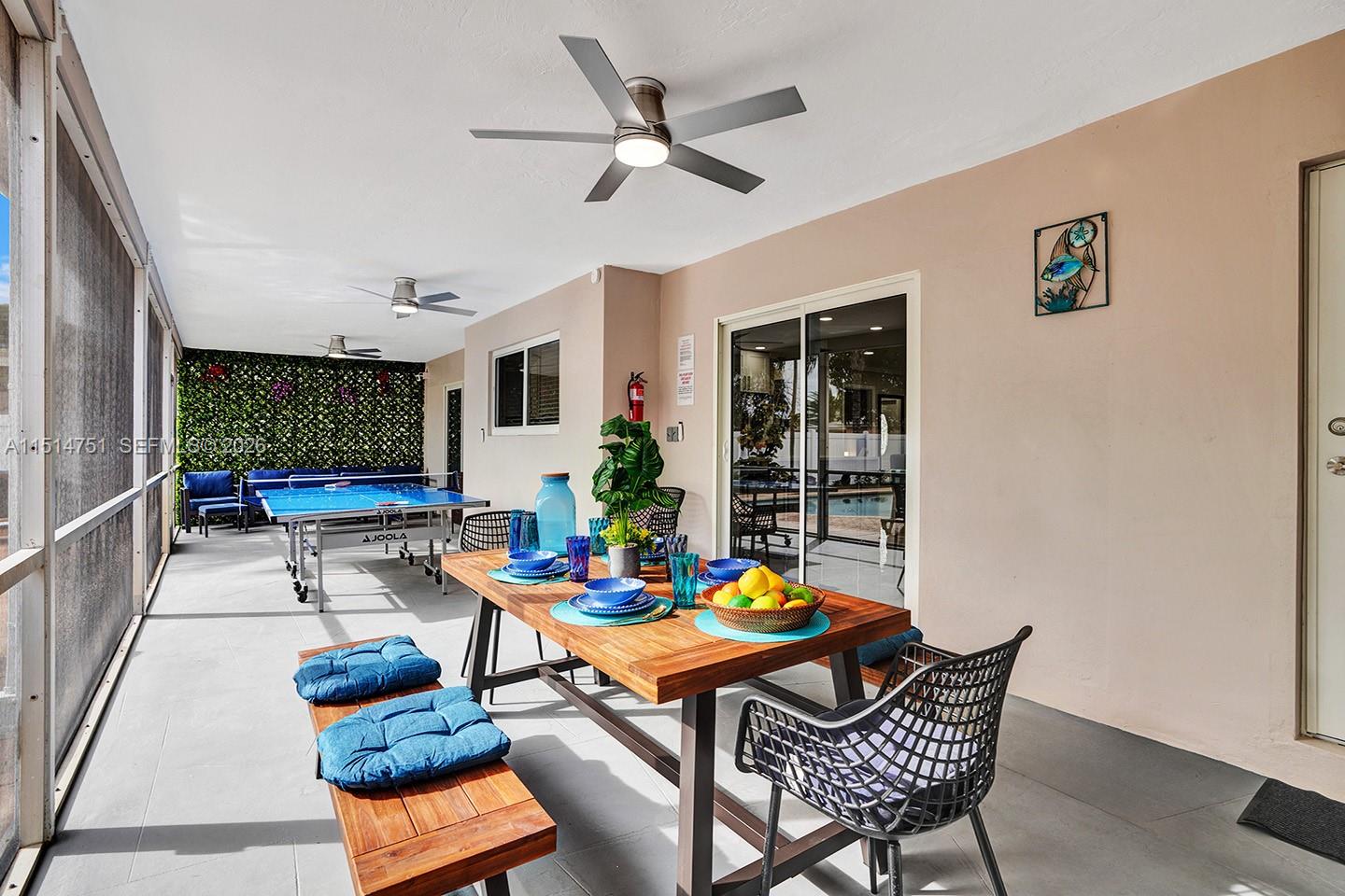 5500 Cleveland Street Hollywood, FL 33021 - Photo 10 of 45 a dining room with furniture a rug and a large window