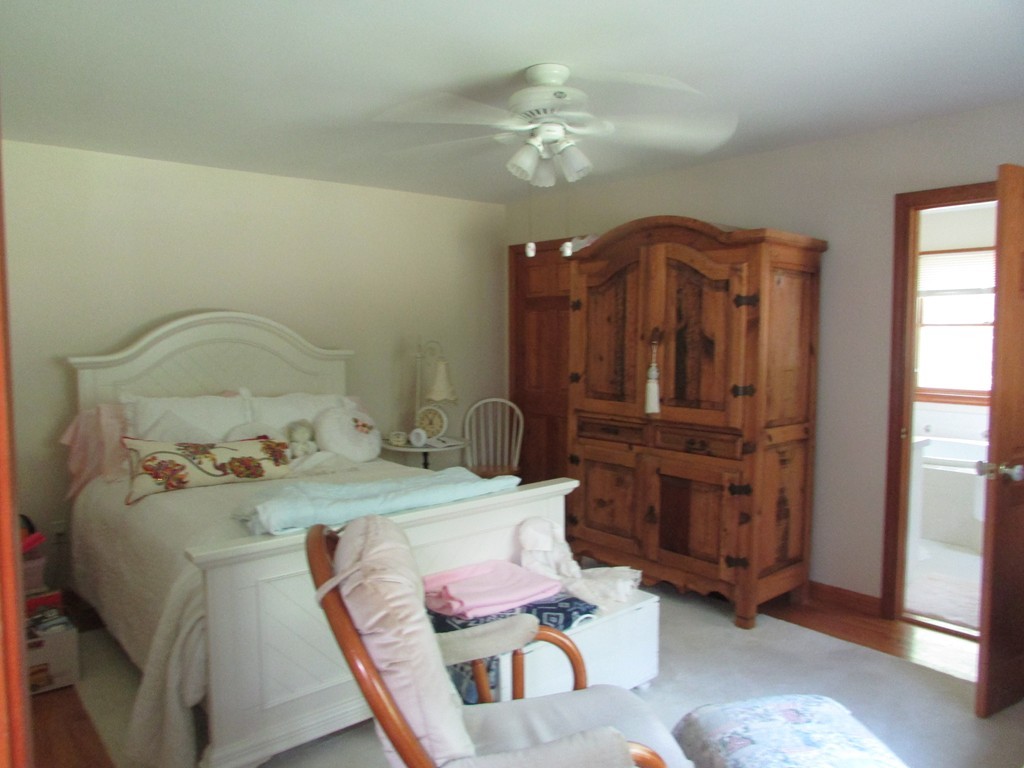 36 R Moody Byfield, MA 01922 - Photo 8 of 19 a bedroom with a bed a chandelier with dresser and mirror