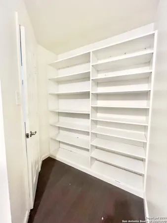 a view of walk in closet with empty racks