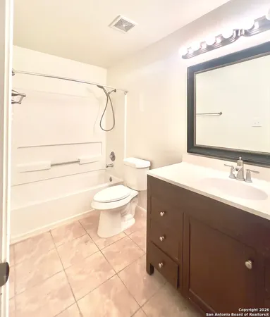 a bathroom with a double vanity sink toilet mirror and shower