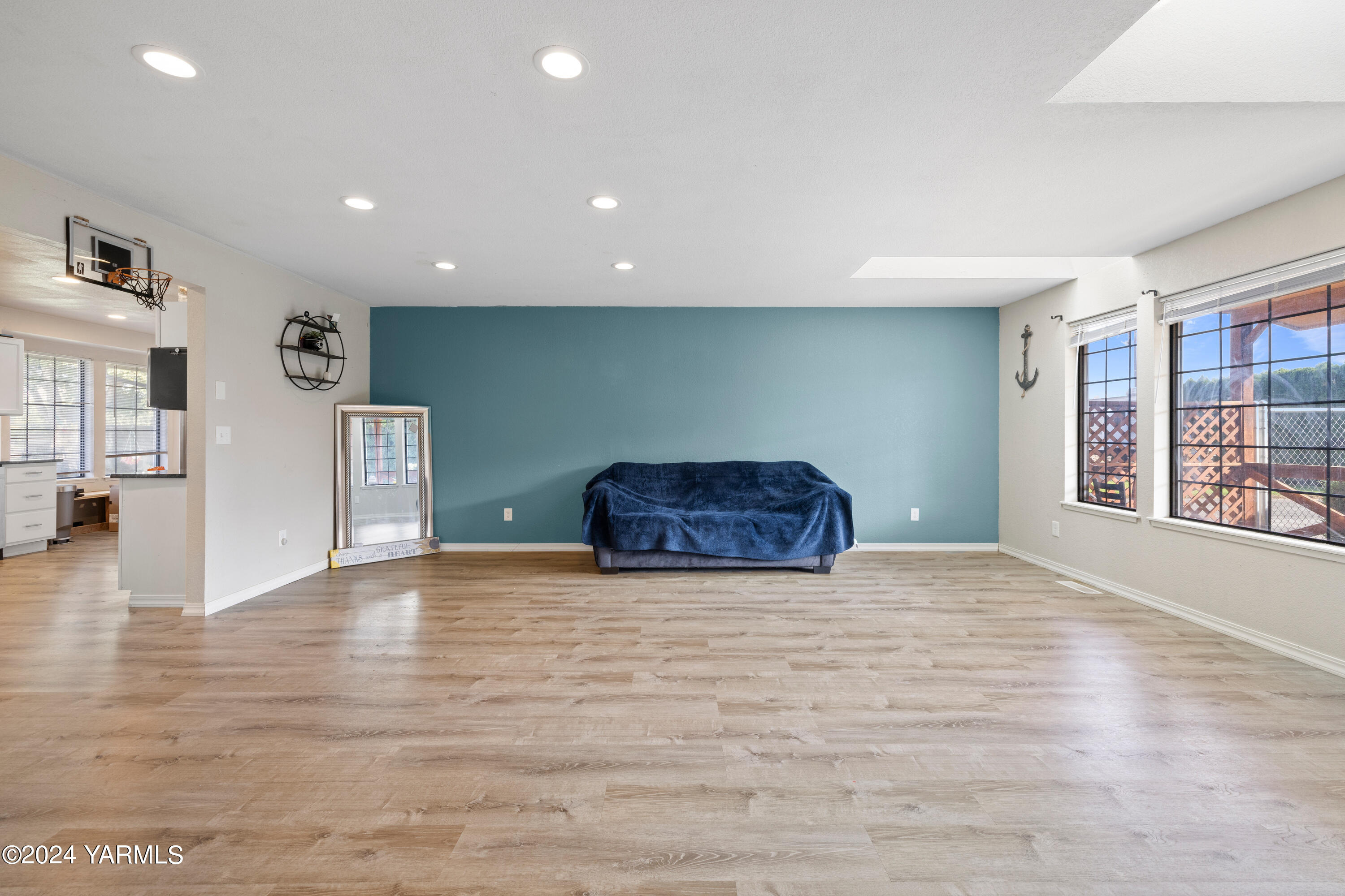 341 Jones Road Wapato, WA 98951 - Photo 8 of 18 a view of an empty room with window and wooden floor