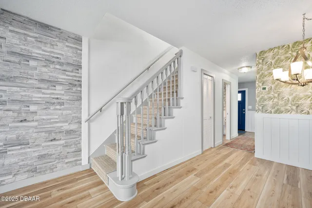a view of entryway with wooden floor and stairs