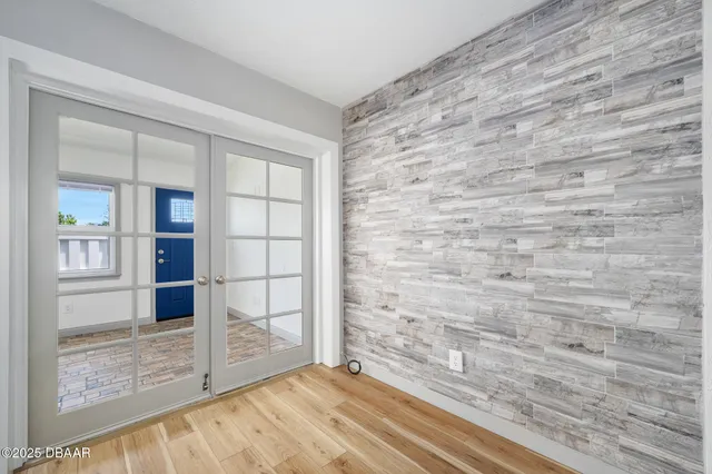 a view of wooden floor and brick walls