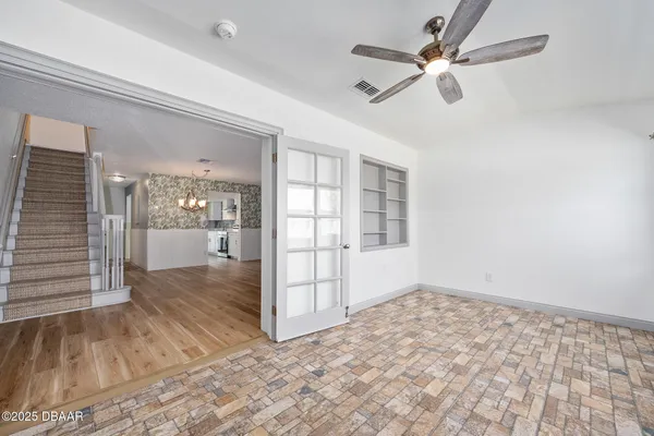 wooden floor in an empty room with a window