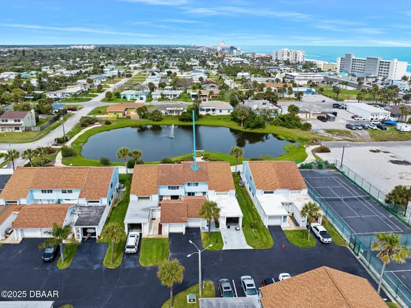 an aerial view of residential houses with outdoor space