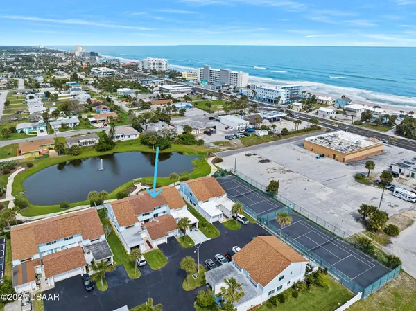 an aerial view of residential houses with outdoor space