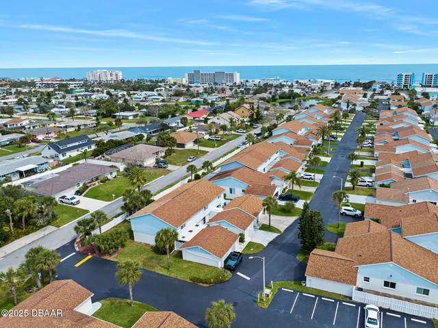 an aerial view of residential houses with outdoor space