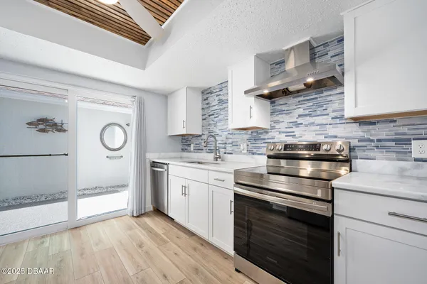 a kitchen with stainless steel appliances granite countertop a stove and a sink