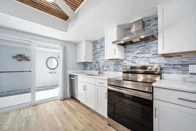 a kitchen with stainless steel appliances granite countertop a stove and a sink