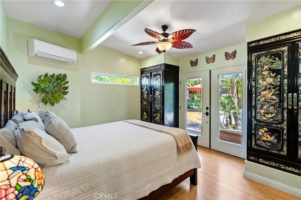 1002 Par Avenue Paso Robles, CA 93446 - Photo 12 of 59 a bedroom with a large bed and a chandelier