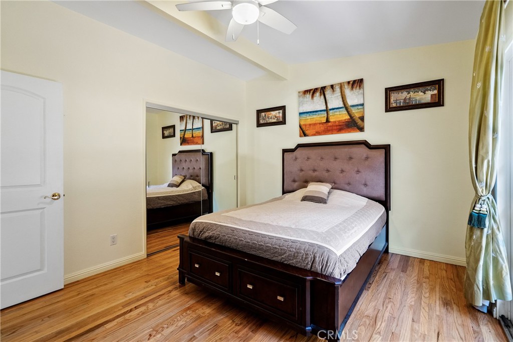 1002 Par Avenue Paso Robles, CA 93446 - Photo 18 of 59 a bedroom with a bed and a chandelier