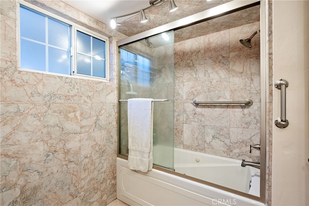 1002 Par Avenue Paso Robles, CA 93446 - Photo 23 of 59 a bathroom with a bathtub and a shower