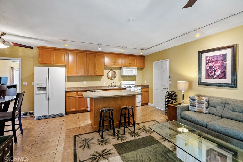 1002 Par Avenue Paso Robles, CA 93446 - Photo 29 of 59 a living room with stainless steel appliances kitchen island granite countertop furniture and a large window