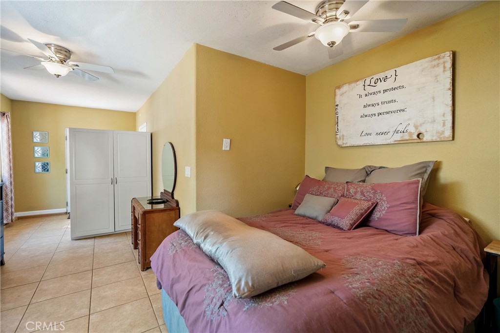 1002 Par Avenue Paso Robles, CA 93446 - Photo 37 of 59 a bedroom with a bed and a chandelier