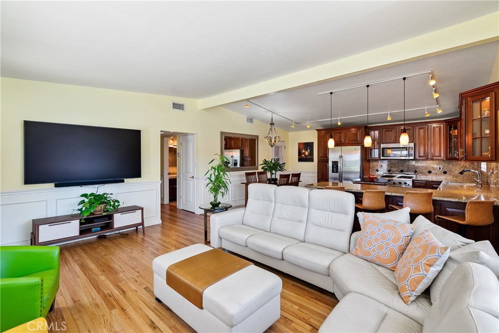 1002 Par Avenue Paso Robles, CA 93446 - Photo 6 of 59 a living room with furniture kitchen view and a flat screen tv