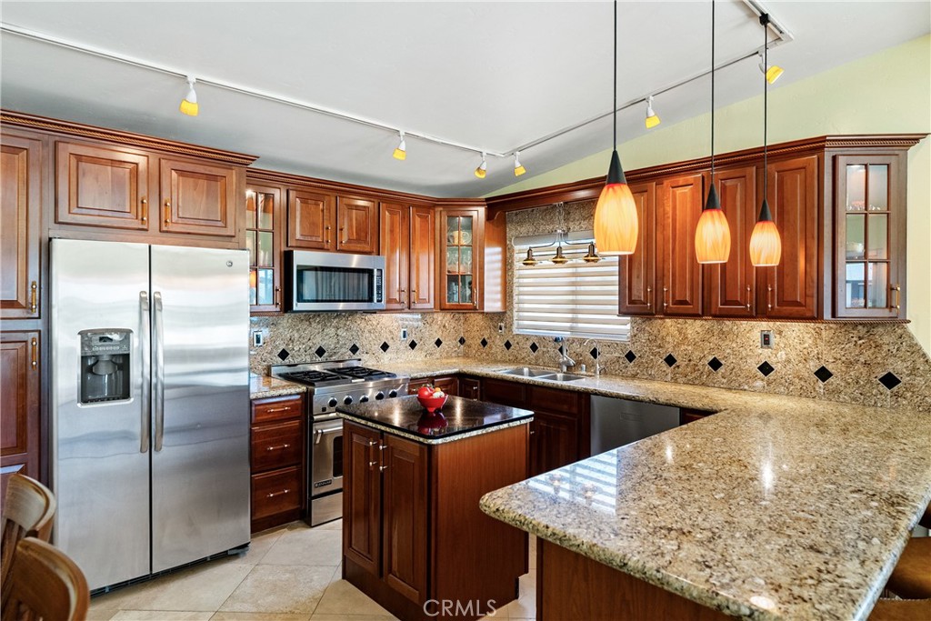 1002 Par Avenue Paso Robles, CA 93446 - Photo 9 of 59 a kitchen with stainless steel appliances granite countertop a sink stove and refrigerator