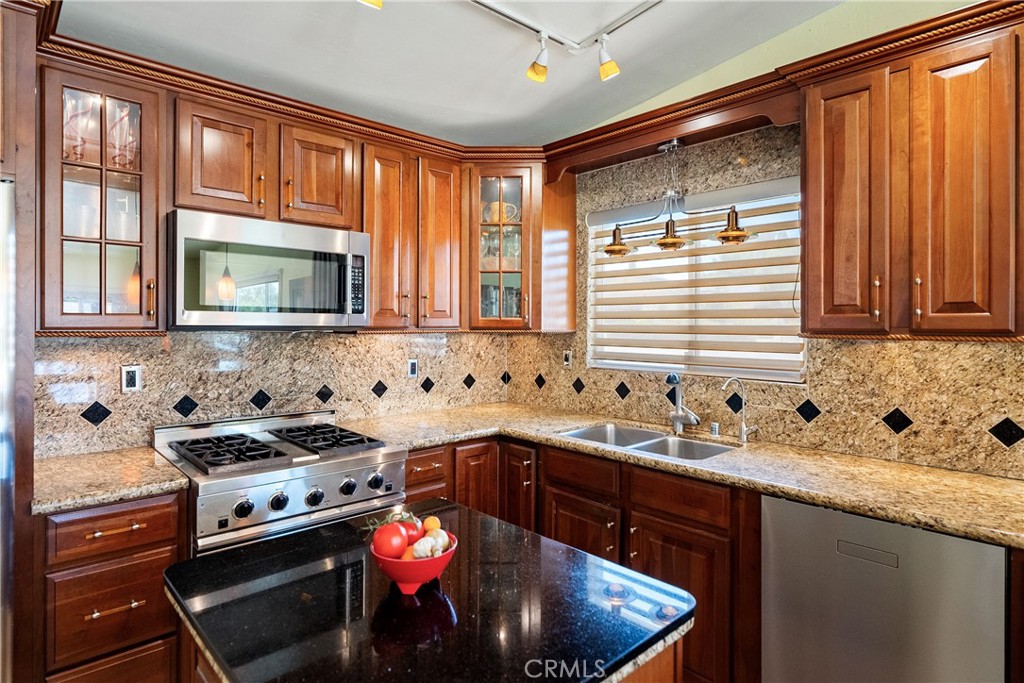 1002 Par Avenue Paso Robles, CA 93446 - Photo 10 of 59 a kitchen with stainless steel appliances granite countertop a sink stove and microwave