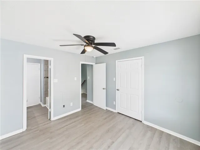 a view of a livingroom with a ceiling fan and wooden floor