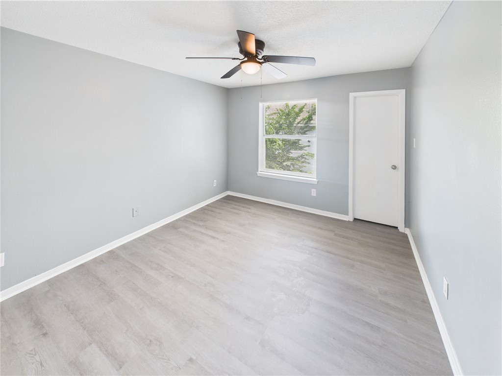 1104 Verde Drive, Unit D Bryan, TX 77801 - Photo 9 of 11 an empty room with window and a ceiling fan