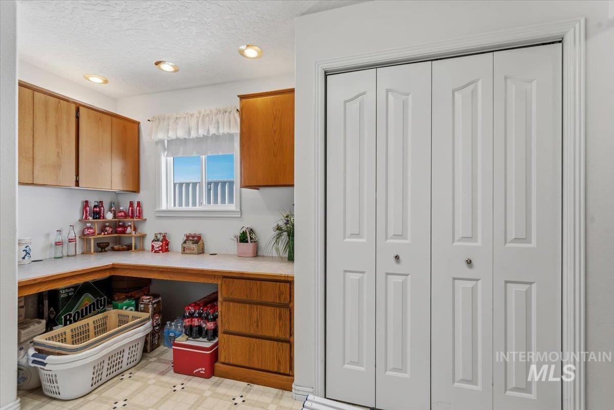 2331 Gulley Road Homedale, ID 83628 - Photo 29 of 46 Functional utility space featuring a built-in countertop, wood cabinetry, and recessed lighting