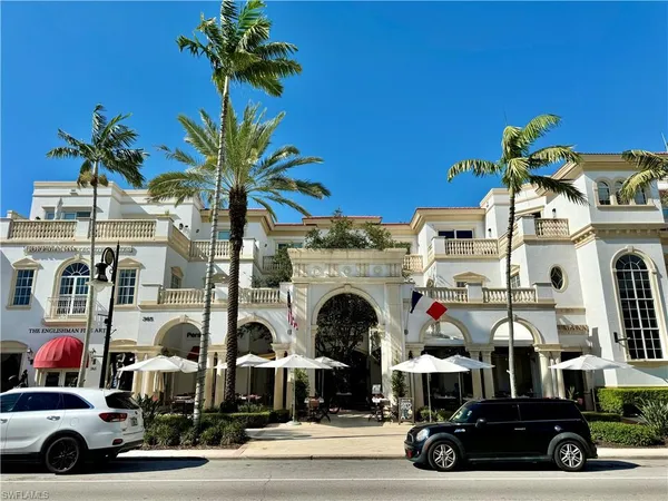 a view of a cars park in front of a building