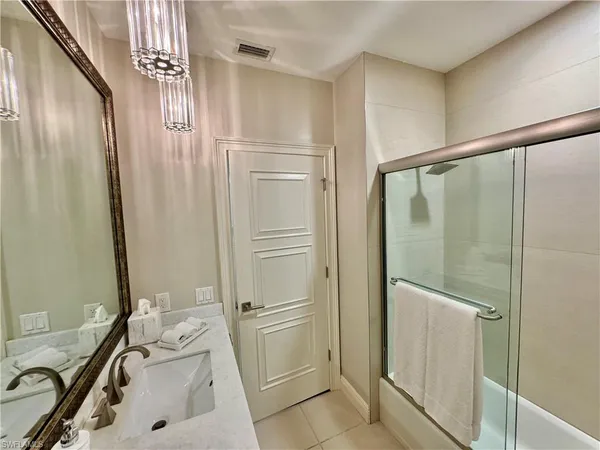 a bathroom with a tub shower and sink
