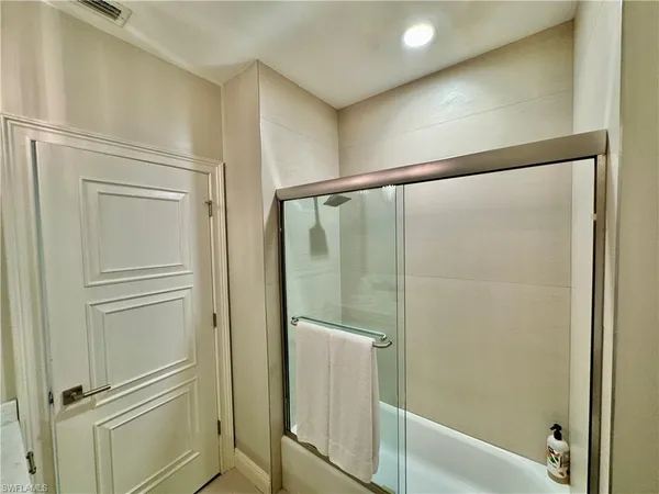 a bathroom with a glass shower door