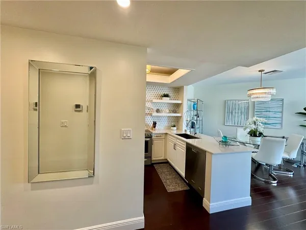a kitchen with a sink cabinets and wooden floor