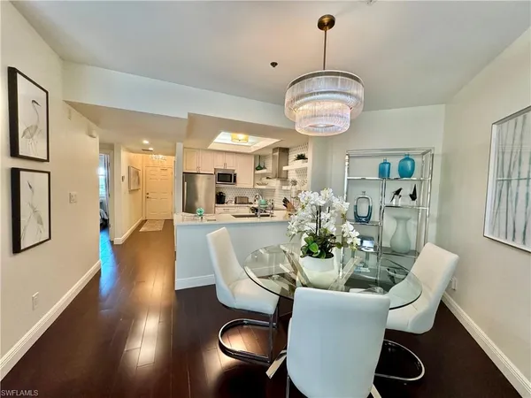 a view of a dining room with furniture wooden floor and chandelier