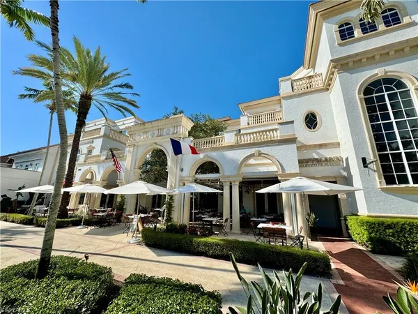 a front view of multiple houses with yard