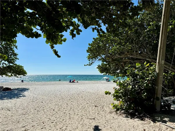 a view of a lake with beach and outdoor space