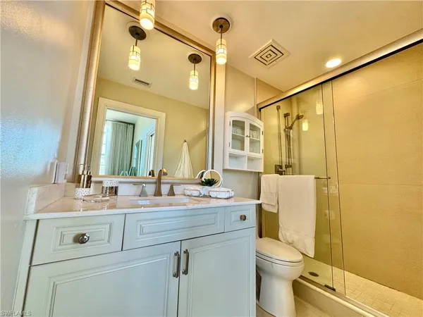 a bathroom with a sink mirror vanity and toilet