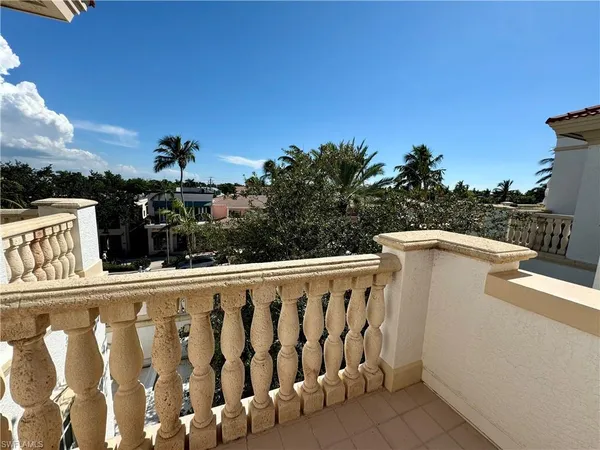 a view of a balcony with wooden fence and floor