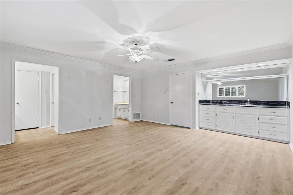 2505 Oak Manor Court Arlington, TX 76012 - Photo 11 of 23 a view of a kitchen with an empty space cabinets and a ceiling fan