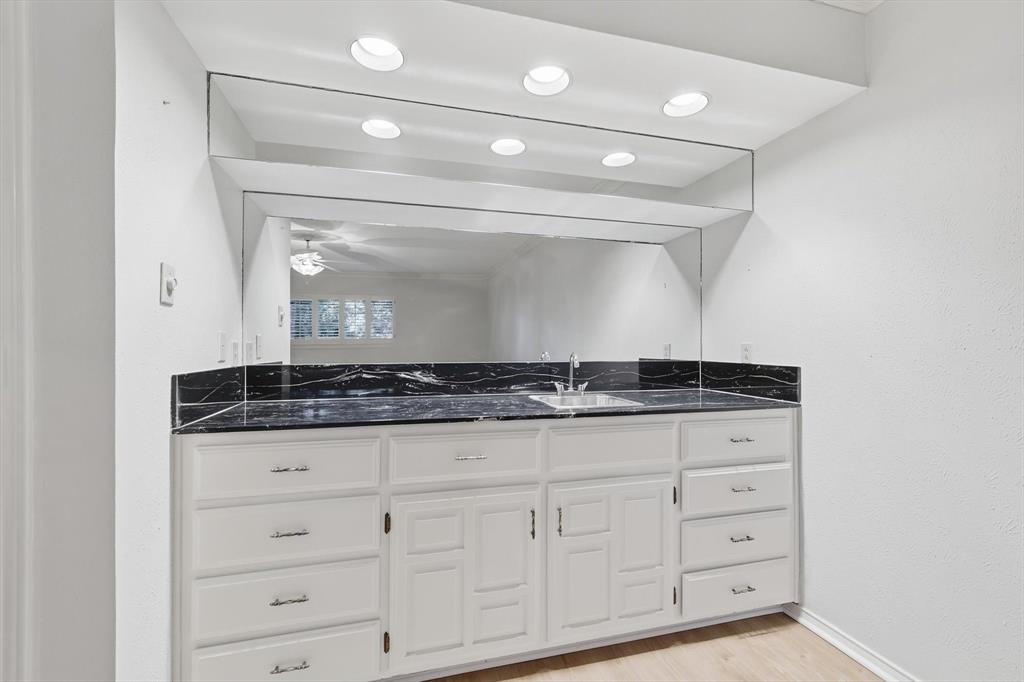 2505 Oak Manor Court Arlington, TX 76012 - Photo 12 of 23 a bathroom with a granite countertop double vanity sink and white cabinets